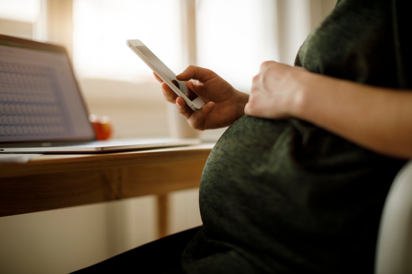 Pregnant woman using mobile phone